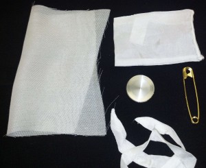 Coin, silk bag, reinforcement fabric, brass safety pin